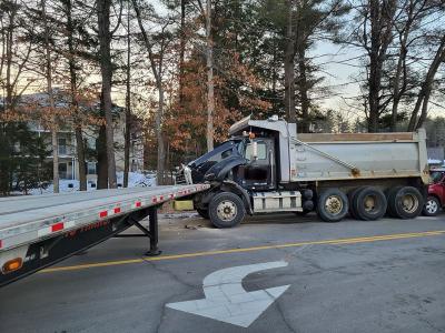 dump truck with front end damage at crash scene