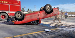 photo showing truck on its roof