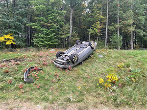driver side view of rolled over vehicle