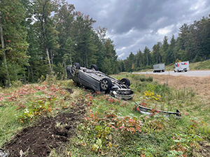 passenger side view of rolled over vehicle