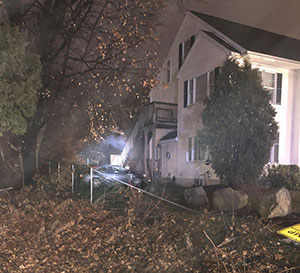 photo showing car crashed into house