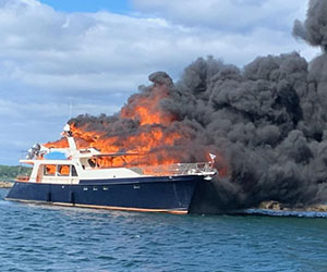 photo depicting full boat on fire