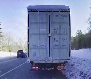 tractor trailer with snow on roof
