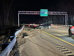 accident scene with car and guardrail
