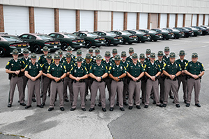 troopers posed in front of cars