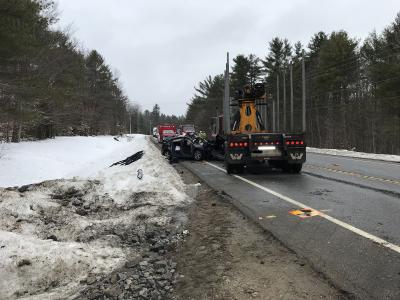 chevy cruze and logging truck at crash scene