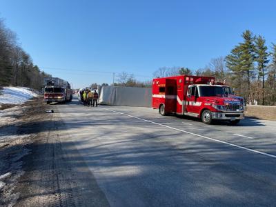 emergency vehicle and rolled over box truck at crash scene